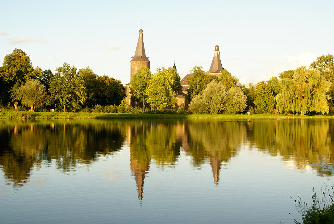 Hoensbroek Castle seen from the Droomvijver pond
